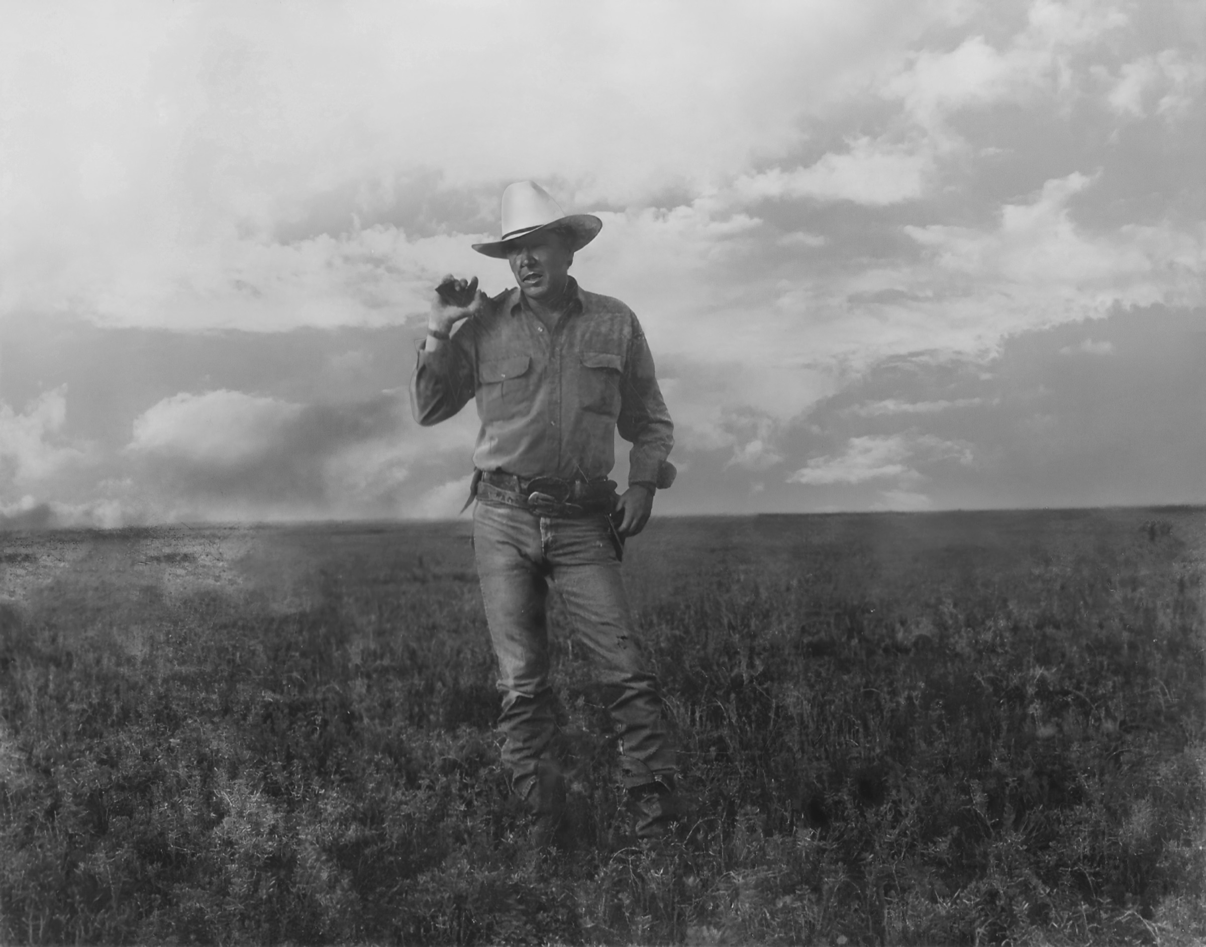 Steve Walker standing in an open field in his cowboy hat, under a wide Texas sky